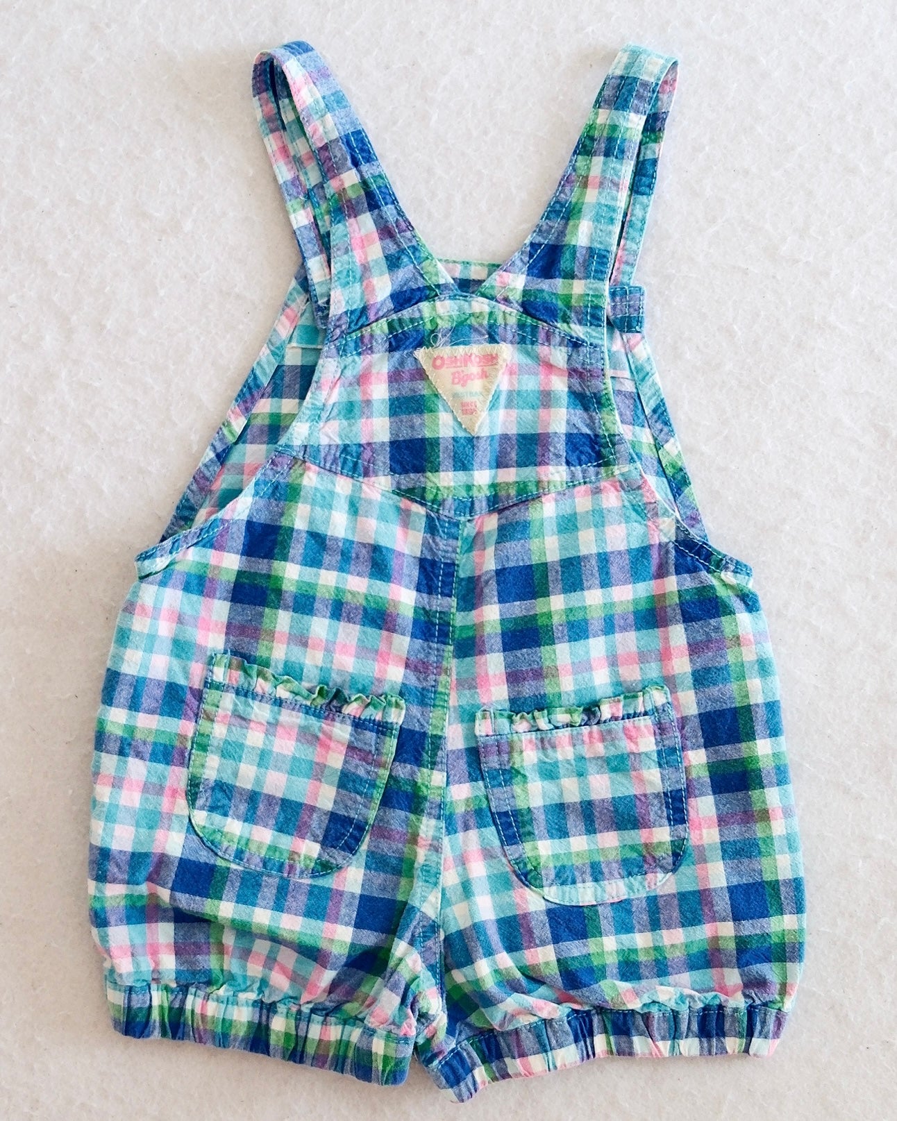 Y2K OshKosh B'Gosh girls blue plaid bubble shortall size 24 months, front flat lay, madras plaid in blue green pink and white, teal flower buttons