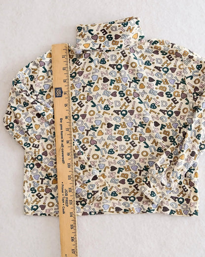Vintage Corner Stone cream alphabet heart print turtleneck
